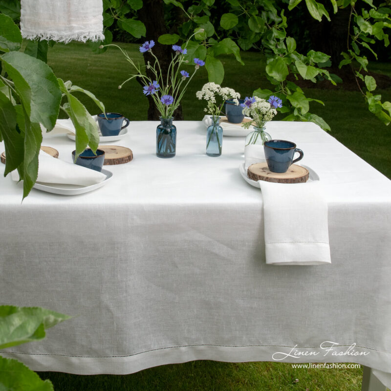 White linen tablecloth with open weave pattern and hemstitch