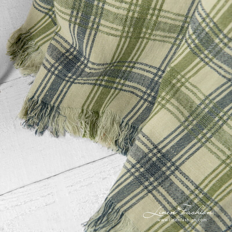 Linen cotton green checked blanket with fringes.