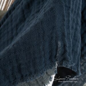 Blue blanket in linen cotton blue with loose fringes.