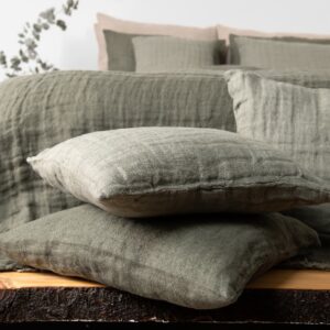 grey green linen bedspread, with decorative cushions