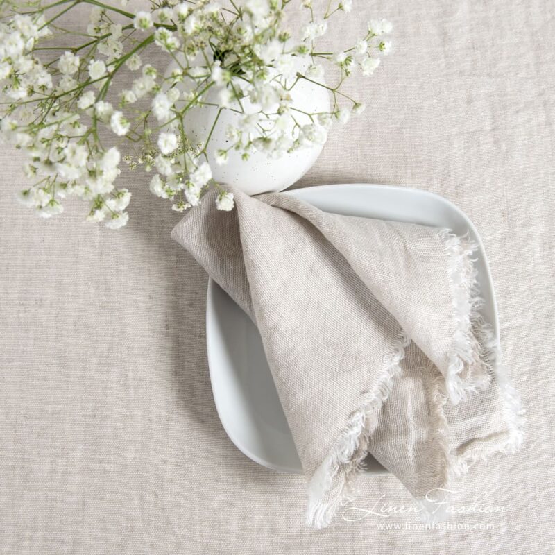 Light grey linen napkin with loose fringes