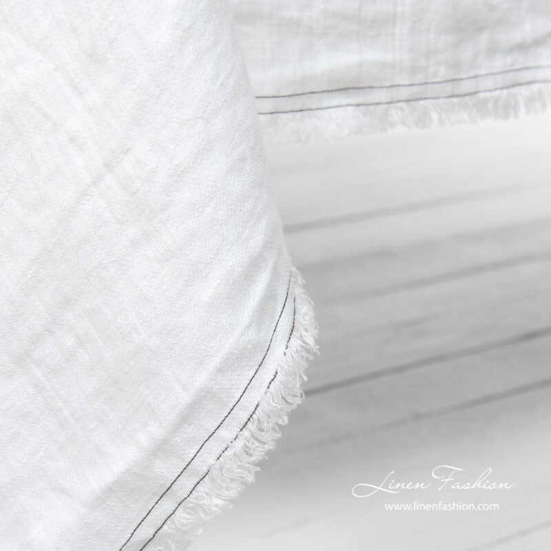 White tablecloth with fringes and double stitches