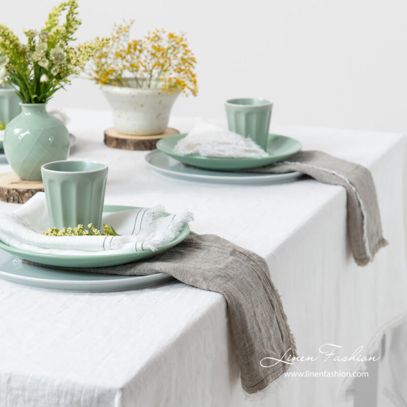 Washed white linen tablecloth with grey napkins