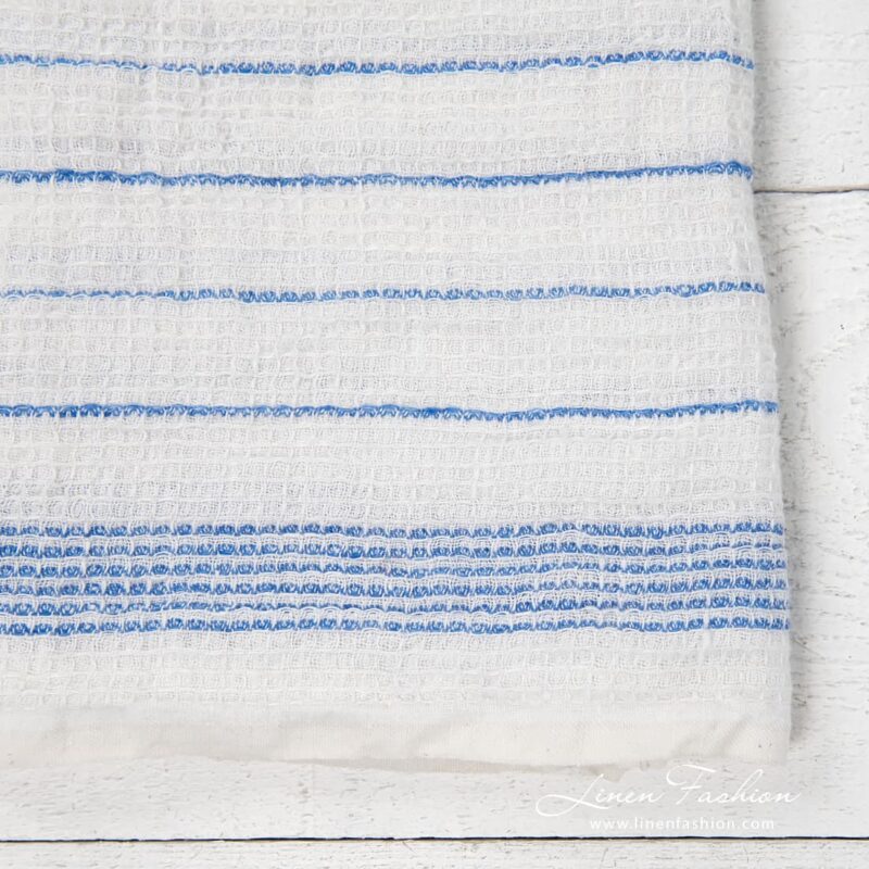 White kitchen towel with blue stripes, waffle weave