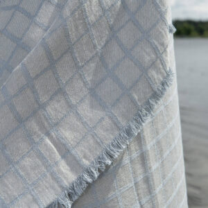 Linen beach towel in blue-grey checks, with fringe