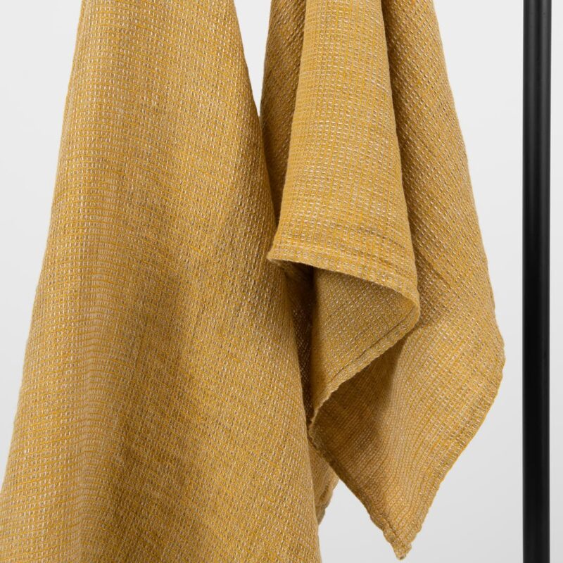 linen yellow bath towel, waffle structure.