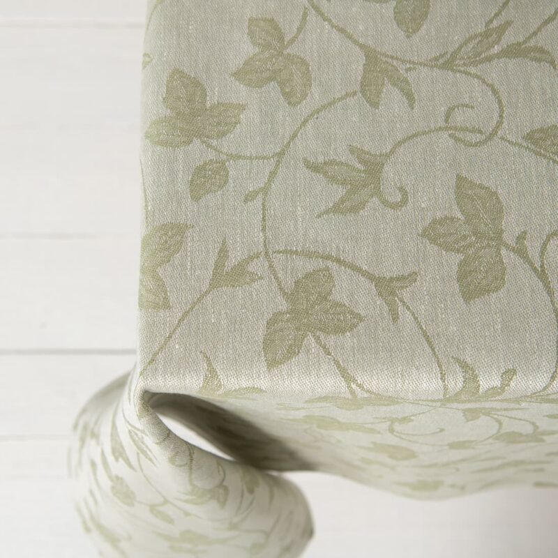 Linen cotton green floral vine pattern tablecloth, table edge top view
