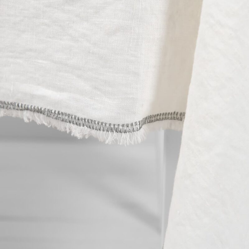 white linen tablecloth with decorative seam in grey color.