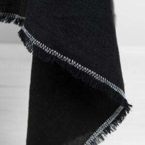 linen black tablecloth with decorative seam in white.