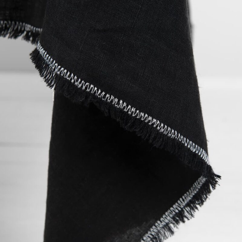 linen black tablecloth with decorative seam in white.