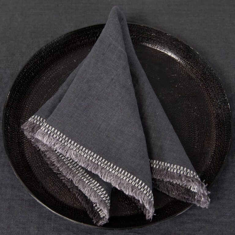 grey linen napkin with decorative stitch.