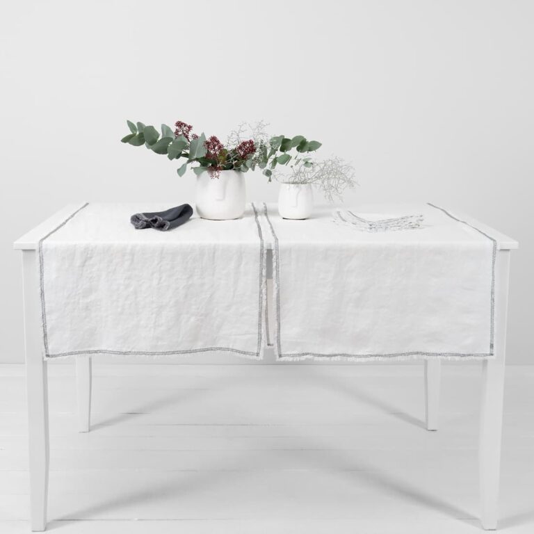 white linen runner with decorative stitch