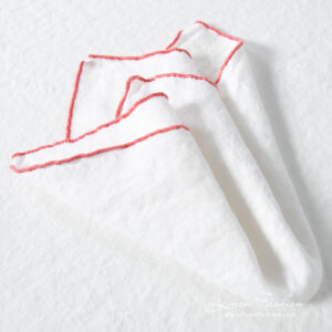 ARVO white linen napkin with rosy Babylock stitch border