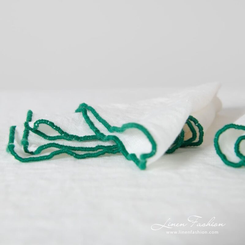 ARVO off-white linen napkin with bright green babylock stitch
