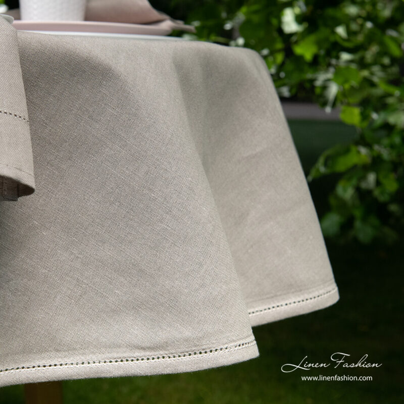 Side view of linen blend dark grey round (oval) tablecloth with hemstitch