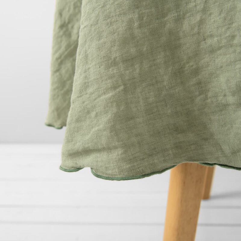 old green linen round tablecloth with decorative stitch