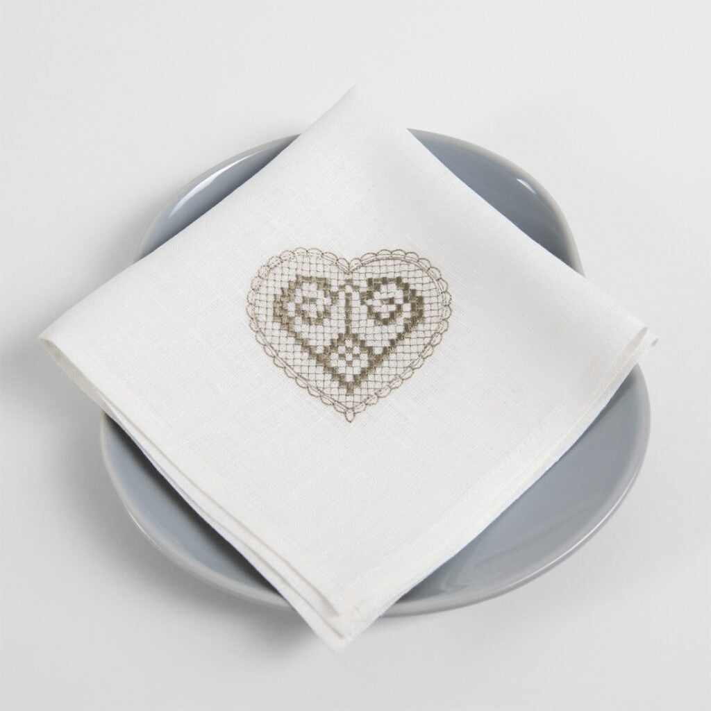 White linen napkin with beige embroidery