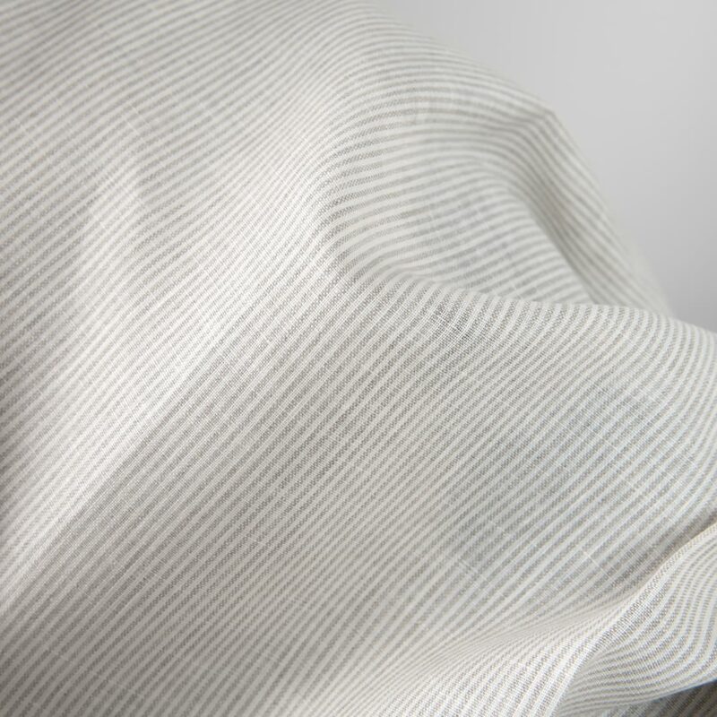 Linen fabric in natural and white colour stripes close up detail view