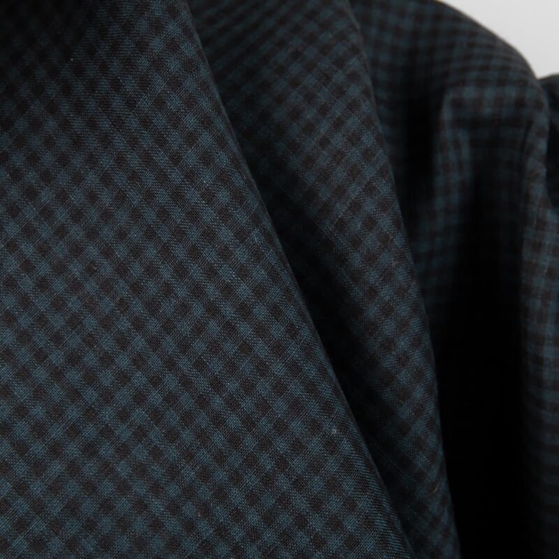 Dark linen fabric in black and blue checks close up detail view