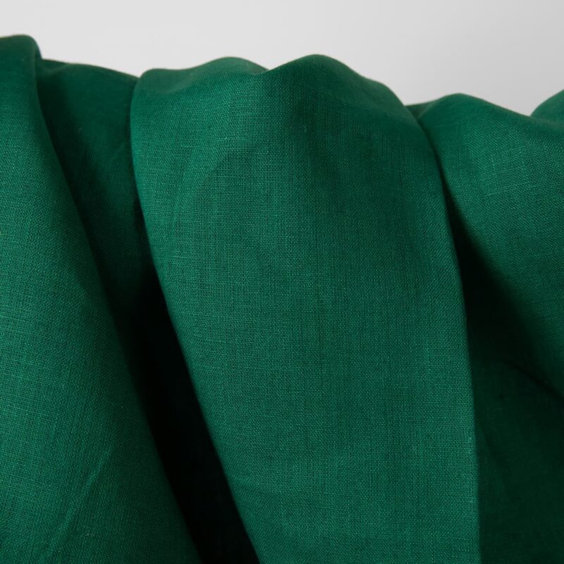 Linen fabric vibrant dark green colour close up detail