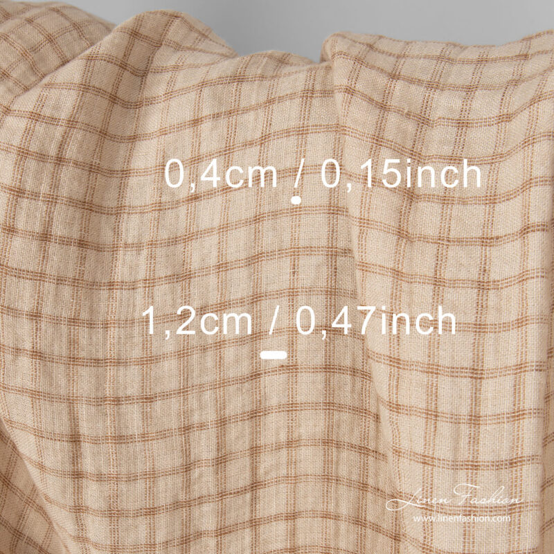 Check measures on washed linen fabric in sand colour