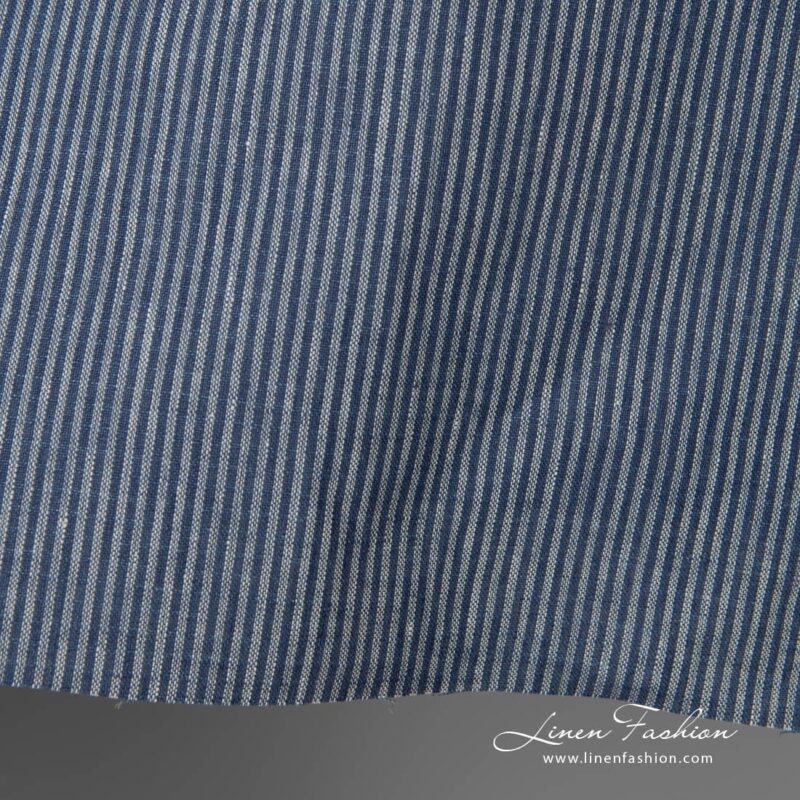 Linen fabric with small blue stripes close edge view