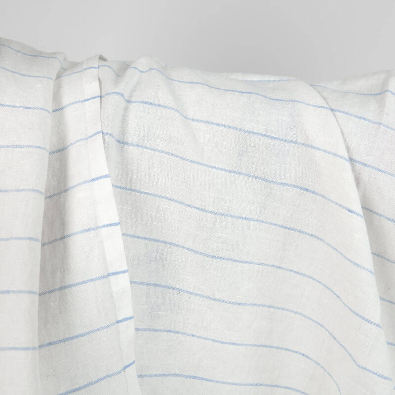 Washed linen cotton fabric white with sky blue stripes close up detail