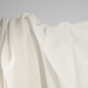 Wide washed linen cotton fabric off-white colour close up detail
