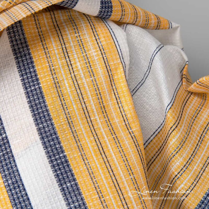 Linen cotton fabric white waffle with yellow blue stripes close up detail