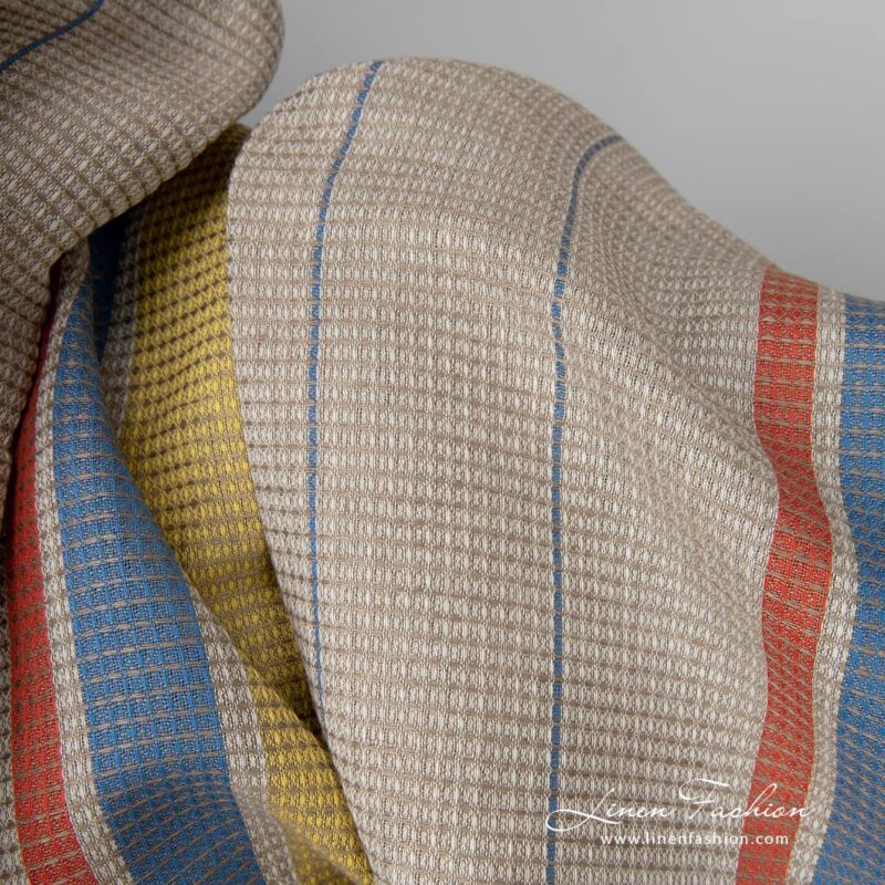 Linen cotton fabric sand waffle with yellow red stripes close up detail