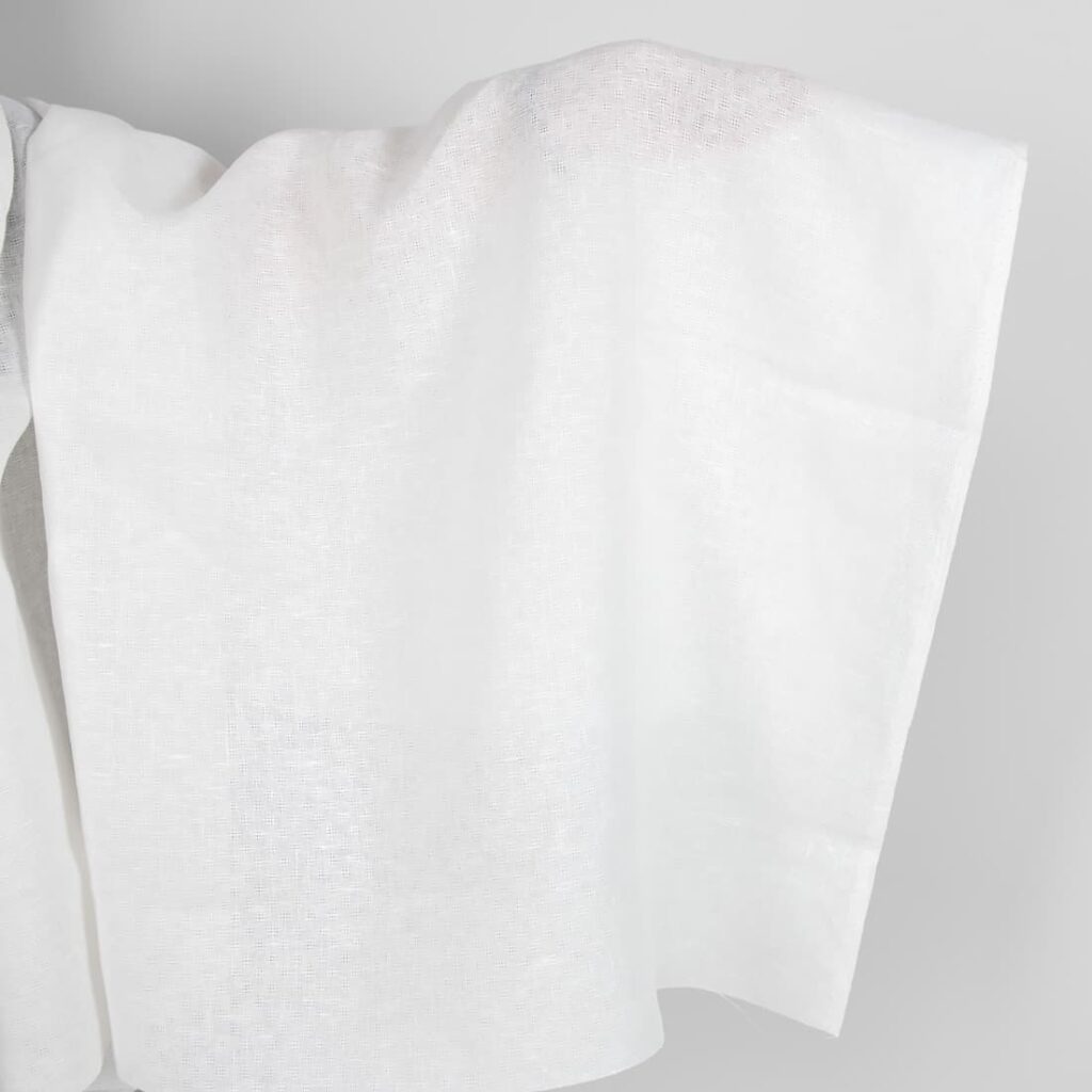 Off-white linen fabric in an openwork pattern