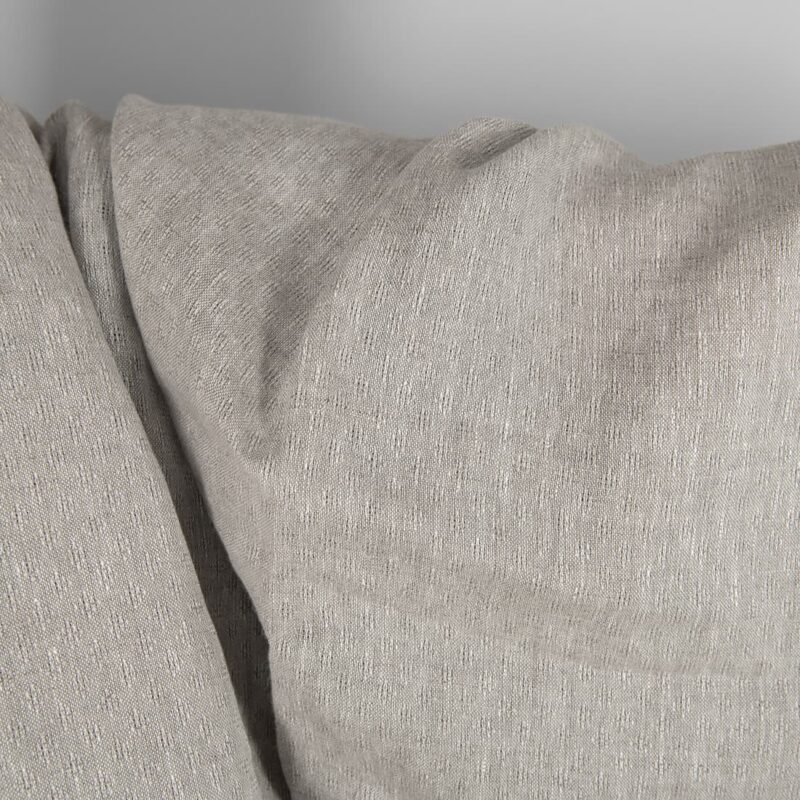 Openwork patterned linen fabric in beige close up detail
