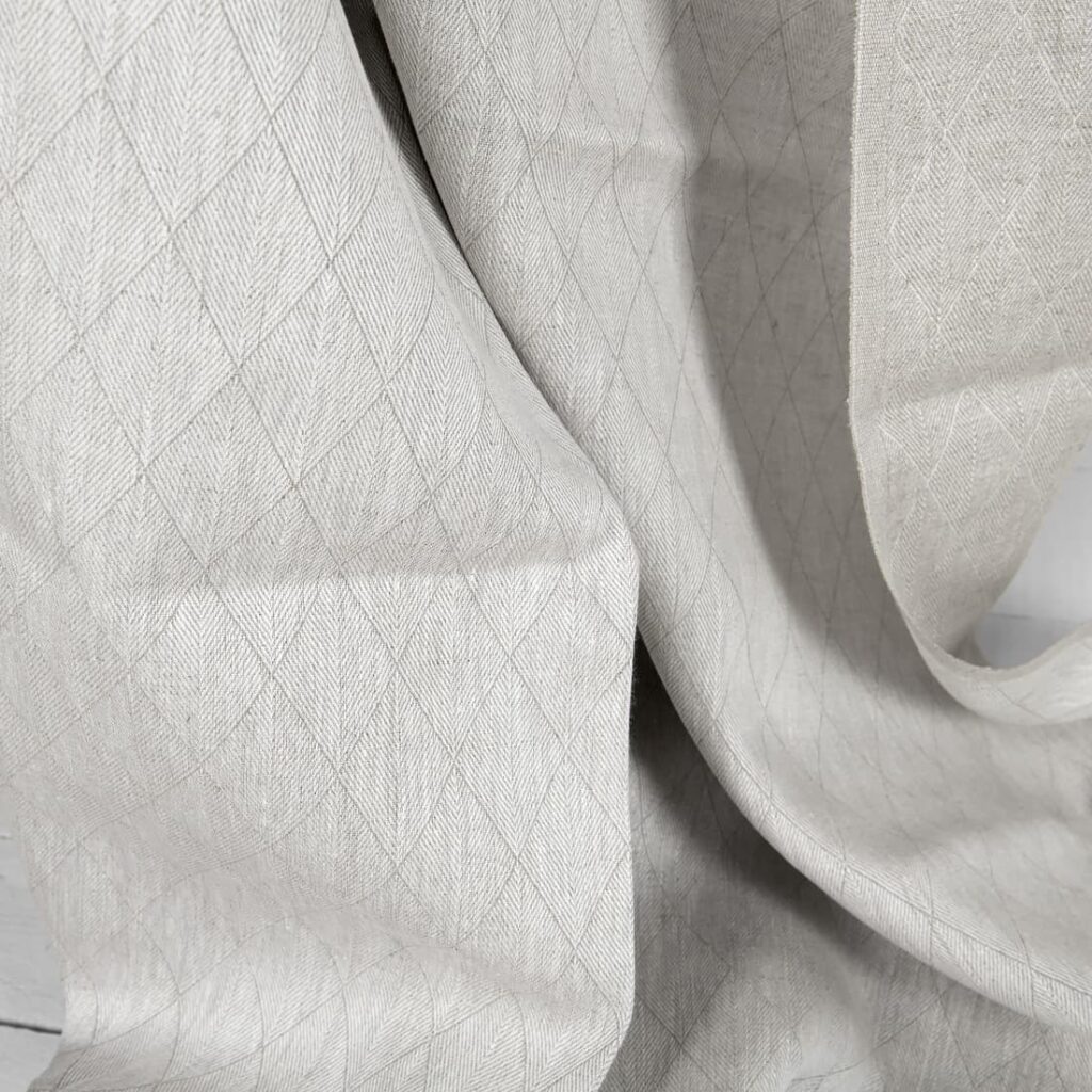 Beżowa dwustronna lniana tkanina w romby 2 Beige double-sided linen fabric in a diamond pattern texture