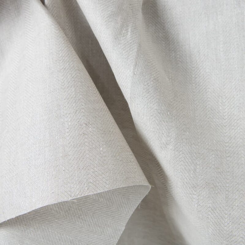 Linen fabric beige in herringbone pattern close up detail