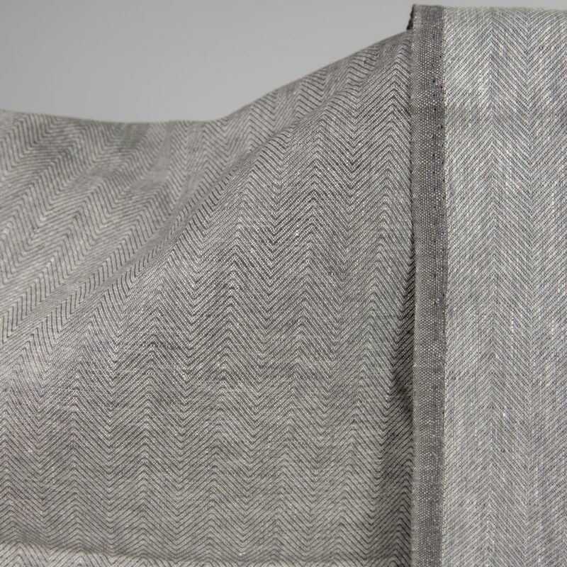 Linen fabric greyish brown in herringbone pattern front side