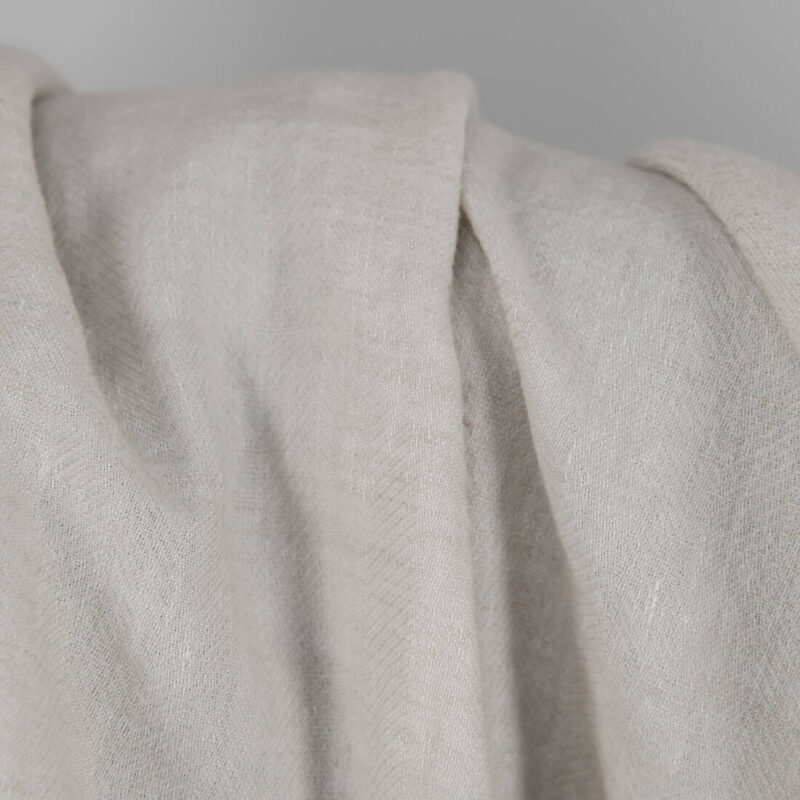 Washed linen wool fabric beige in herringbone pattern texture