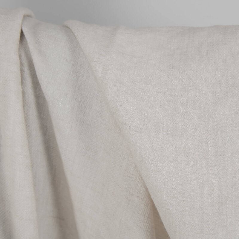 Washed linen wool fabric beige in herringbone pattern close up detail