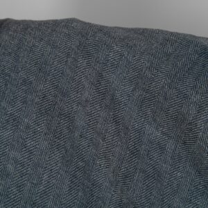 Washed linen wool fabric black white in herringbone pattern close up detail