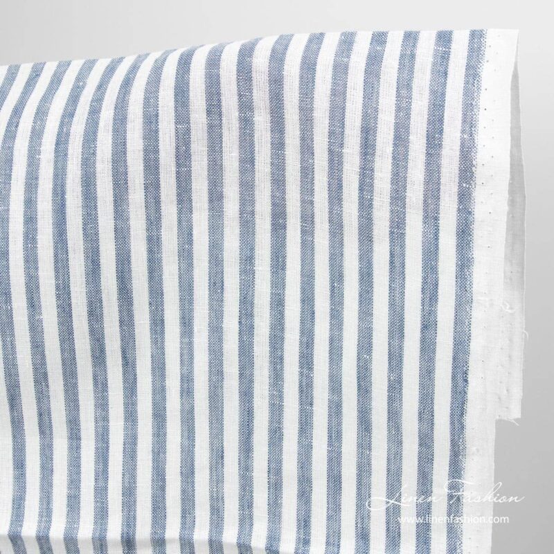 Narrow linen fabric white with denim blue stripes close up detail