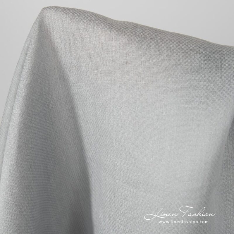 Grey coloured linen fabric, patterned.