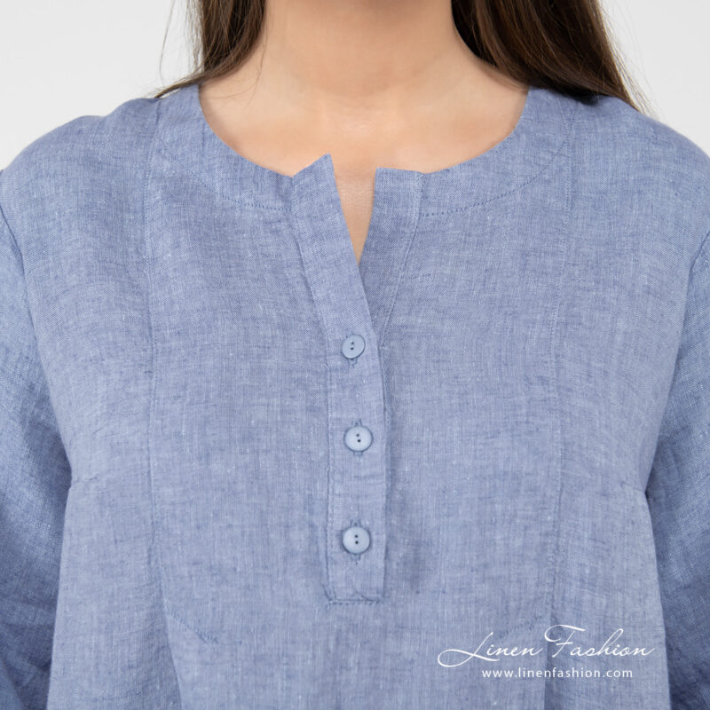 light blue linen dress with rounded neck button closure.