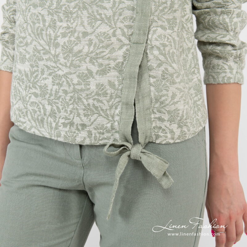 green flower blouse with knotted ribbom at bottom.