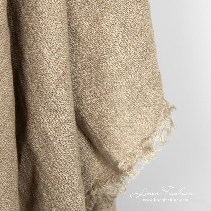 Brownish grey colored scarf of linen fabric.